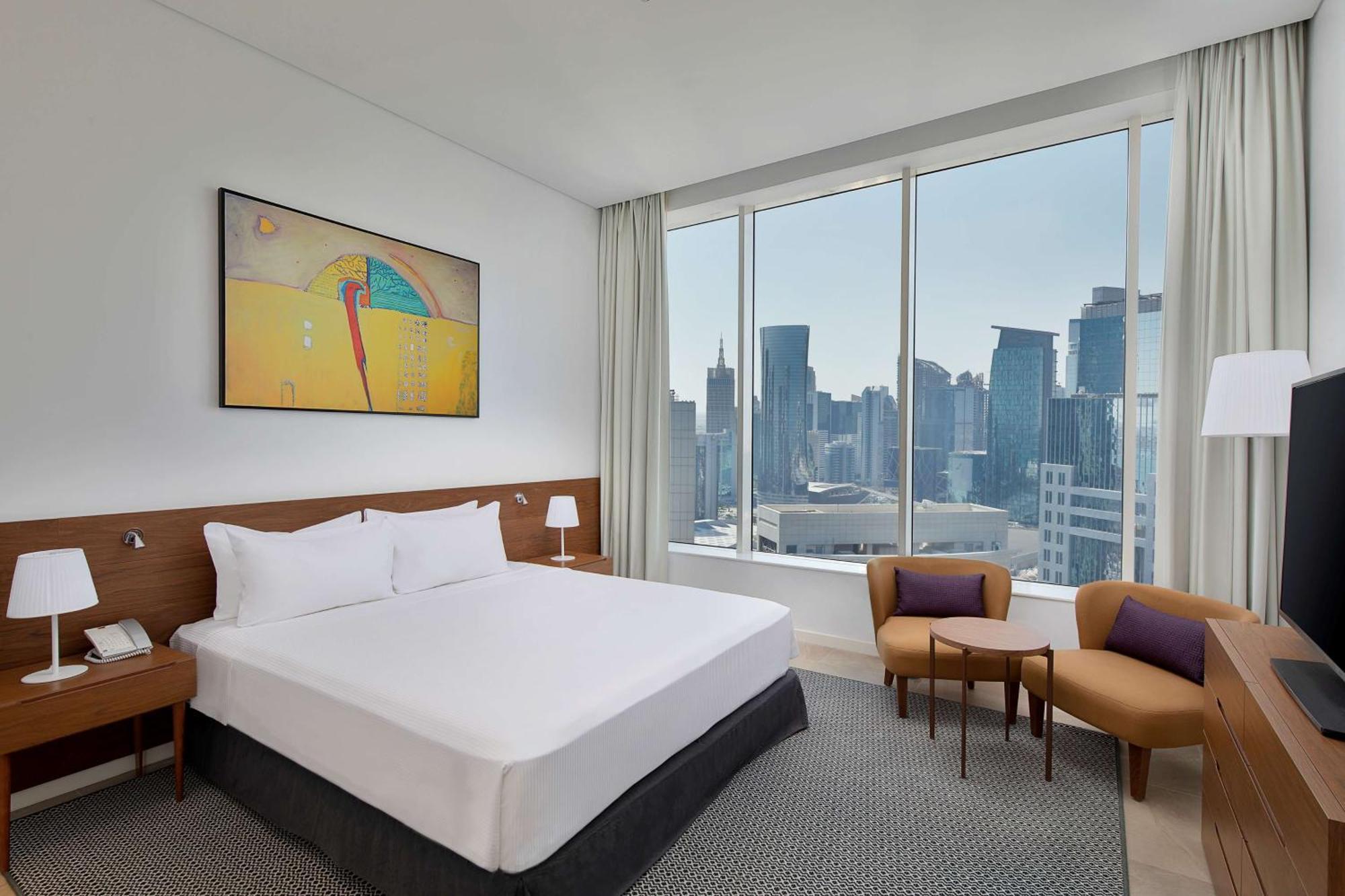 Aleph Doha Residences, Curio Collection By Hilton Exteriér fotografie A bedroom at the hotel